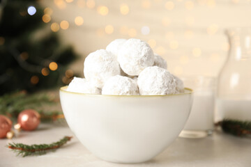 Fototapeta na wymiar Christmas snowball cookies in bowl on light table