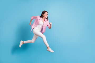 Full size profile photo of charming person running empty space toothy smile white pants isolated on blue color background