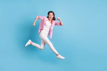 Fototapeta na wymiar Full length portrait of cheerful person jump run hurry open mouth good mood isolated on blue color background