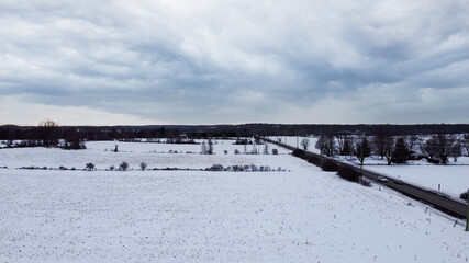 Fototapeta na wymiar Aerial view of a corn field covered by snow, near Huntmar Drive in Kanata, ottawa. Ottawa, Ontario, Canada