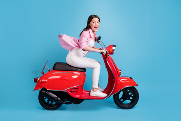 Fototapeta na wymiar Full size side profile photo of attractive impressed person open mouth drive moped isolated on blue color background