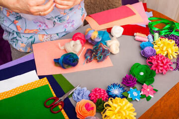 Woman modelling artificial flower from clay