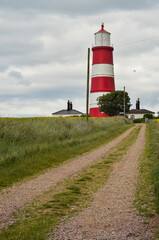 Fototapeta na wymiar Happisburgh lighthouse against cloudy sky.