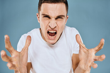 emotional displeased man cropped view white t-shirt blue background