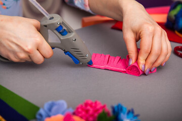 Woman modelling artificial flower from clay