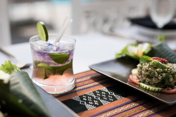 Barman serving cocktail in high end resort by the pool