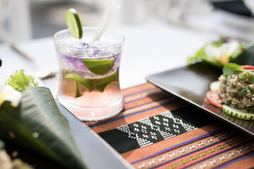 Barman serving cocktail in high end resort by the pool