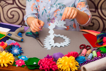Woman modelling artificial flower from clay