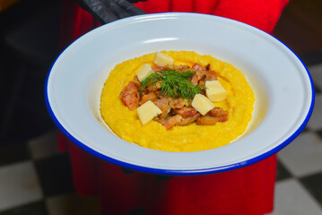 Mashed potatoes served by waiter in a restaurant or diner. Delicious meal idea for dinner.
