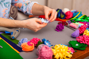 Woman modelling artificial flower from clay