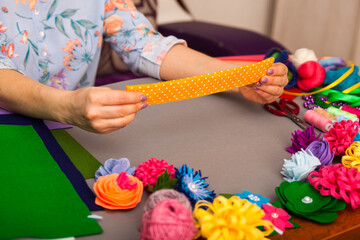 Woman modelling artificial flower from clay