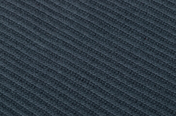 knitted textured background of dark gray color. Close-up of knit and purl loops.