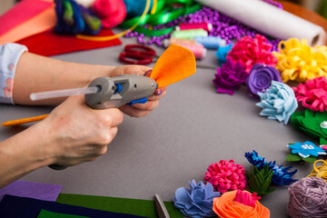 Woman modelling artificial flower from clay