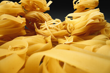 Dry pasta on dark background macro photo