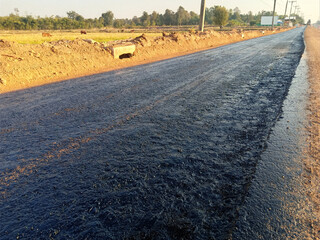 Naklejka premium Rubber spraying for preparation of pavement In road construction