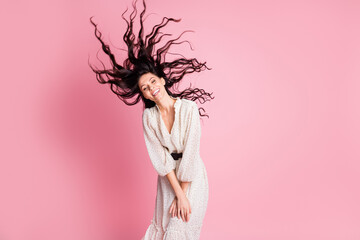 Photo portrait of happy woman throwing long wavy hair laughing in stylish white dress isolated pastel pink color background
