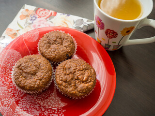 plate with muffins and mug with orange juice	
