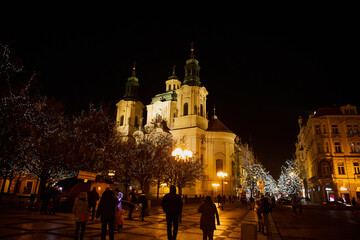 Fototapeta na wymiar Prague, Czech Republic - January 1 2021: Nearly empty Old Town Square with Christmas decorations. Few tourists are visiting this place due to Covid-19 restrictions 