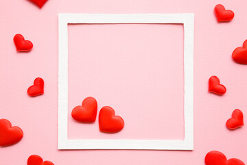 Bright red textile hearts on light pink table background. Pastel color. Empty place for lovely,...