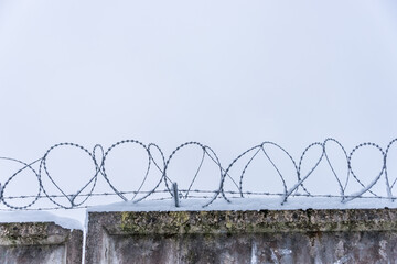 Barbed Wire on an Old Wooden Fence with Snow