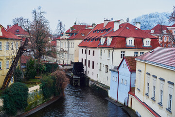 Fototapeta na wymiar Prague, Czech Republic - January 7 2021: Historical watermill in Certovka, view from the Charles Bridge 