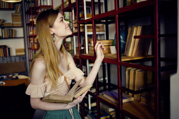 Pretty woman in the library searching book and reading vacation