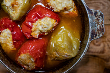 Top view of stewed stuffed peppers in a pot.