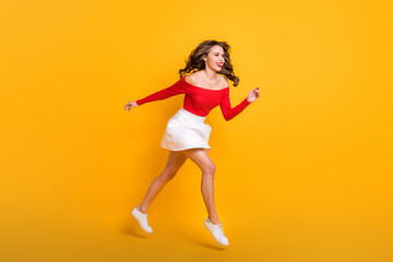 Fototapeta na wymiar Full length body size photo jumping girl running fast on sale black friday laughing isolated on bright yellow color background copyspace