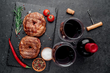 grilled beef steaks in the form of 8 and a bottle of wine, glasses on a stone background. 8 march celebration concept	