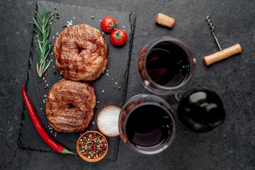 grilled beef steaks in the form of 8 and a bottle of wine, glasses on a stone background. 8 march celebration concept	