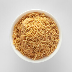 Indian spicy snacks (Namkeen) - Bikaneri Besan Bhujia, made with chickpea flour (Besan), top view against white background.