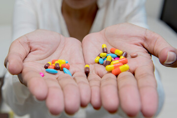 Crazy women eating many pills in hand
