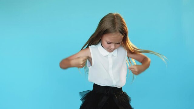Offended little girl. Unhappy situation. Anger emotion. Lost chance. Looser feelings. Pretty female kid crossing hands chest turning back with sadness isolated blue copy space.
