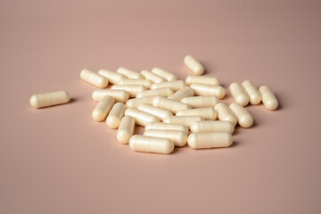 White capsules placed on a
beige background