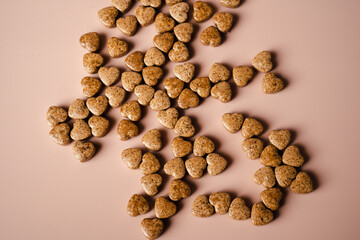 Heart shaped pills on beige background
