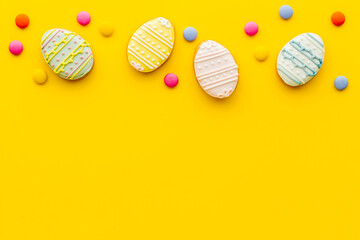 Top view of Easter cookies eggs and sweets. Space for text
