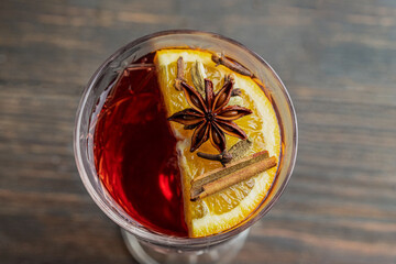 Top view of Mulled wine crystla glass decorated with orange slice and star anise, cloves and...