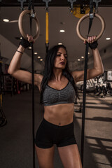 Young female in gym. Young woman working out. Girl in gym training hard.