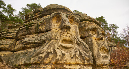 Fototapeta na wymiar Stone carvings near Zelizy in Central Bohemia, called Devils heads