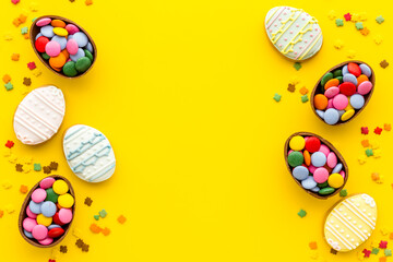 Happy Easter with chocolate eggs and sweets, top view