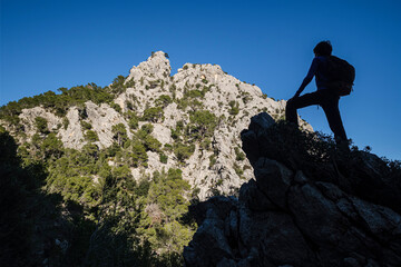 silhouette of a hiker in front of Puig d'en Grau, 867 m , Escorca, Mallorca, Balearic Islands, Spain