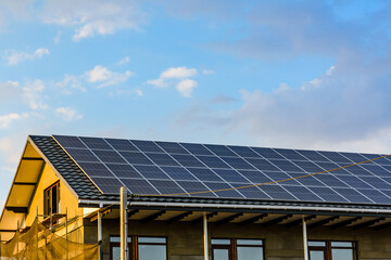 Fototapeta premium Solar panels on roof of residential house. Clean energy. Ecological concept