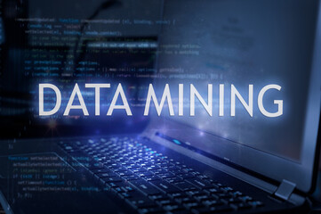 Data mining inscription against laptop and code background.