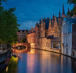 Obraz premium Photo of historic medieval buildings along the canal in Bruges