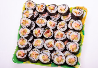 Top view of stack of Japanese sushi maki roll plate. Served in Japanese bar restaurant with chopstick