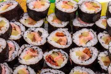 Top view of stack of Japanese sushi maki roll plate. Served in Japanese bar restaurant with chopstick