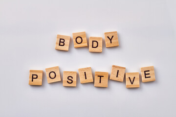 Body positive wooden cubes. Isolated on white background.