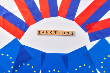 Concept of sanctions between european union and russia. EU flags and russian flags on white...