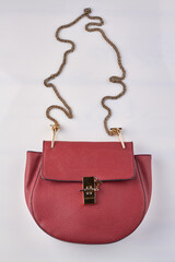 Red leather purse. Vertical shot white background.