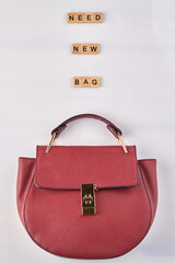 Need new bag. Red leather handbag on white background.